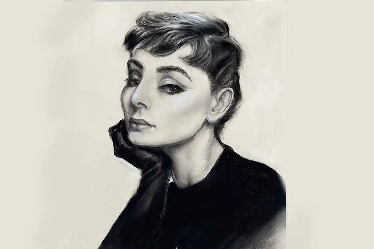 Charcoal portrait study of Audrey Hepburn, capturing a classic three-quarter pose with soft shading and refined facial features.